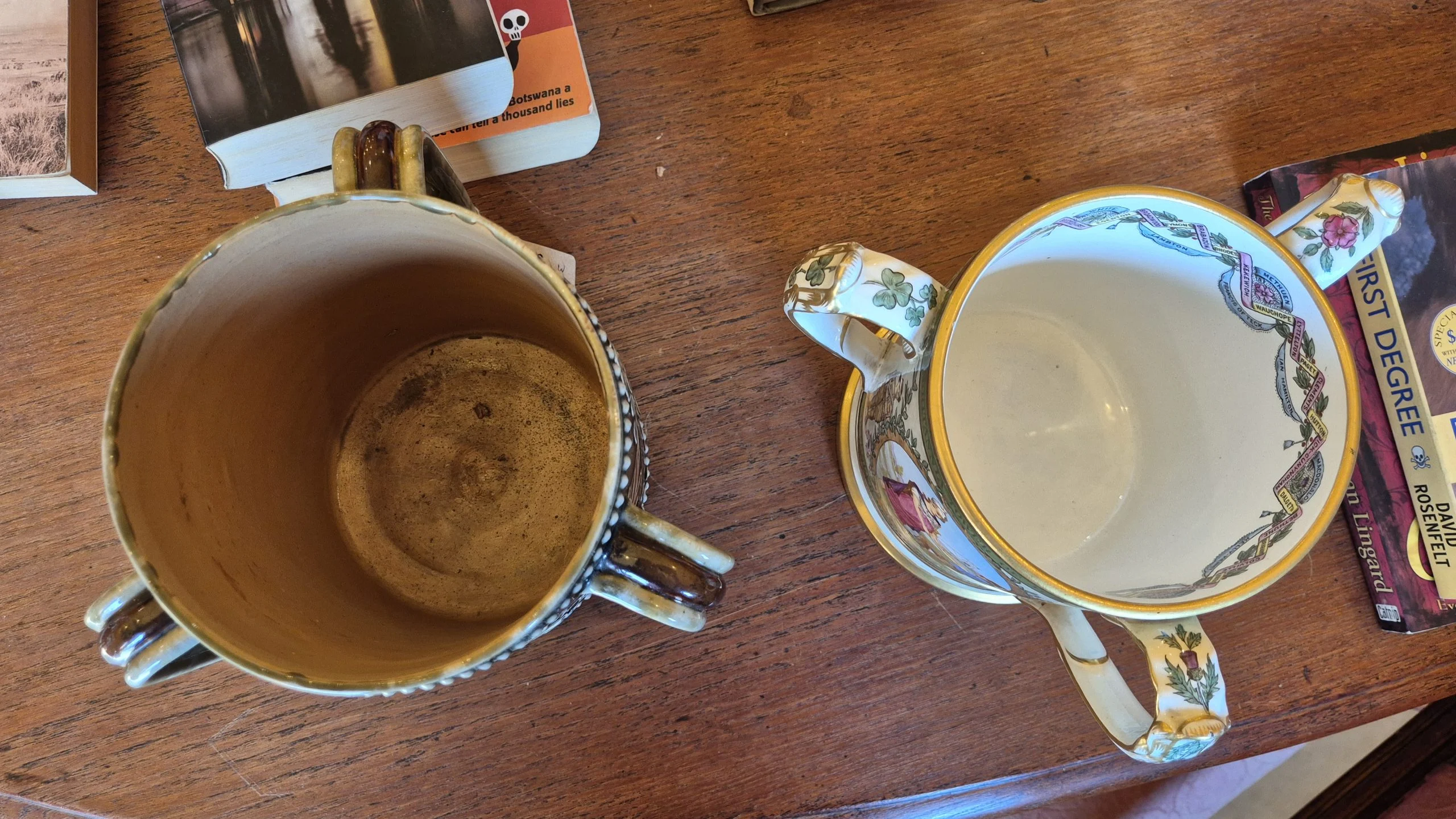 Top-down view of two Anglo-Boer War tygs showing the three handles on each mug.
