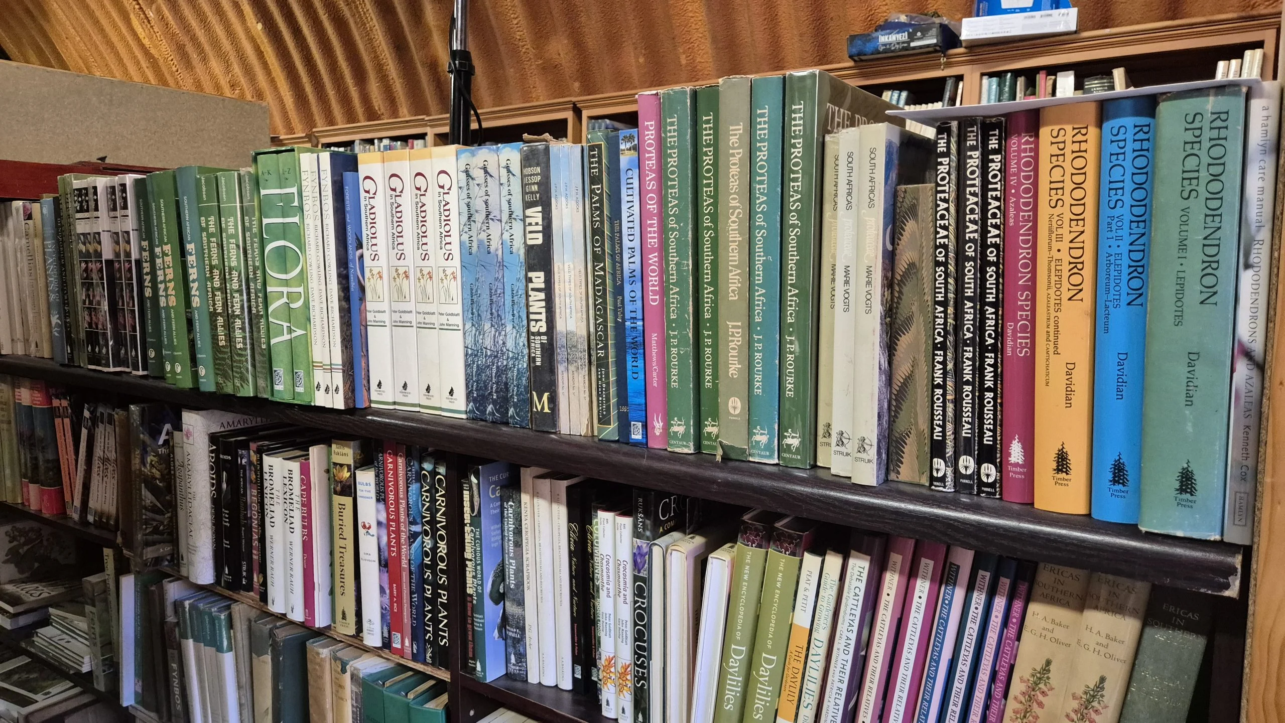 South African botany books on the shelves at Midlands Books in Howick, including flora, proteas and rhododendron volumes.