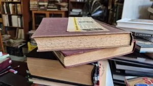 Brown foxing spots spread across the aged pages of an old book