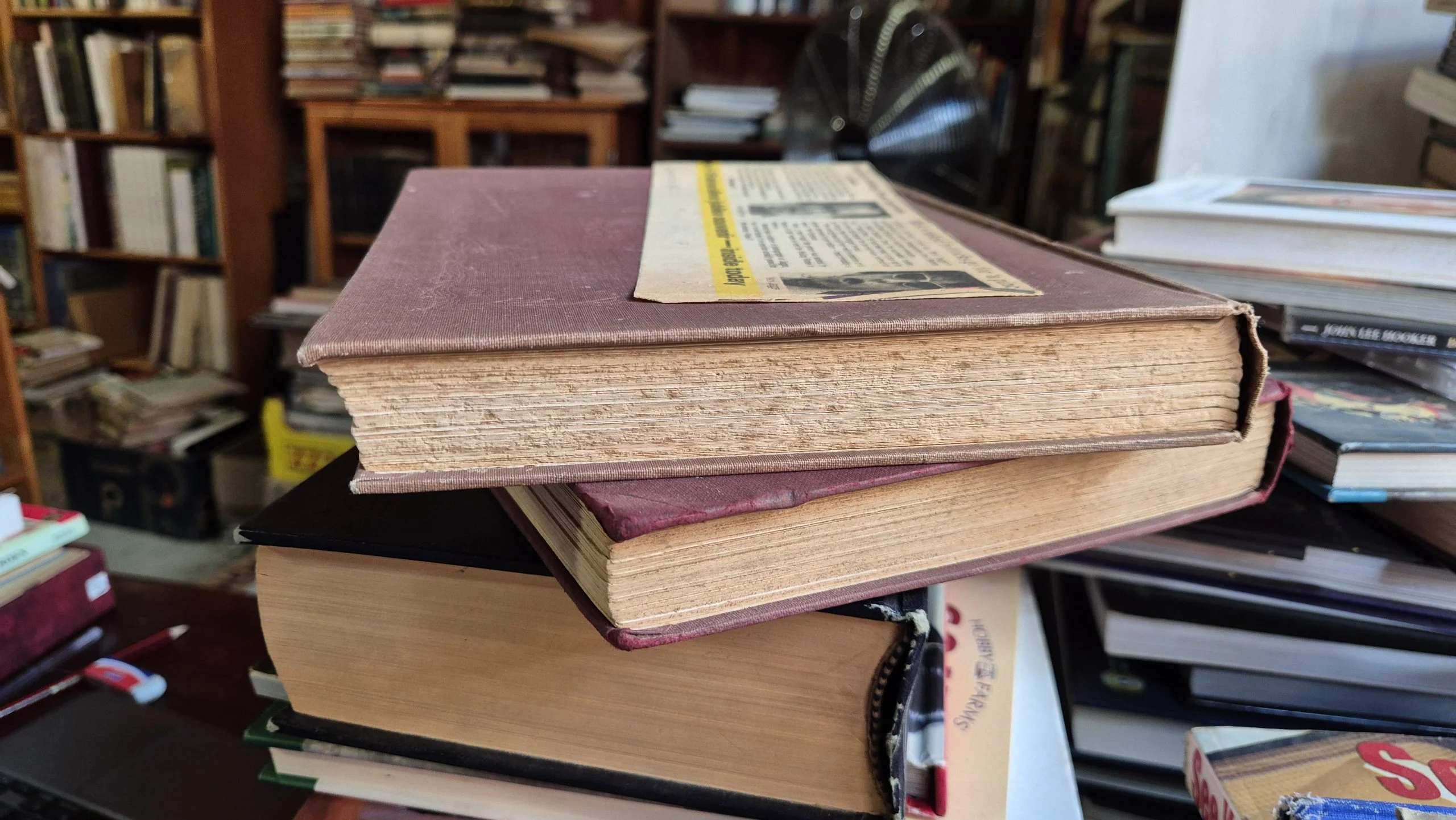 Brown foxing spots spread across the aged pages of an old book
