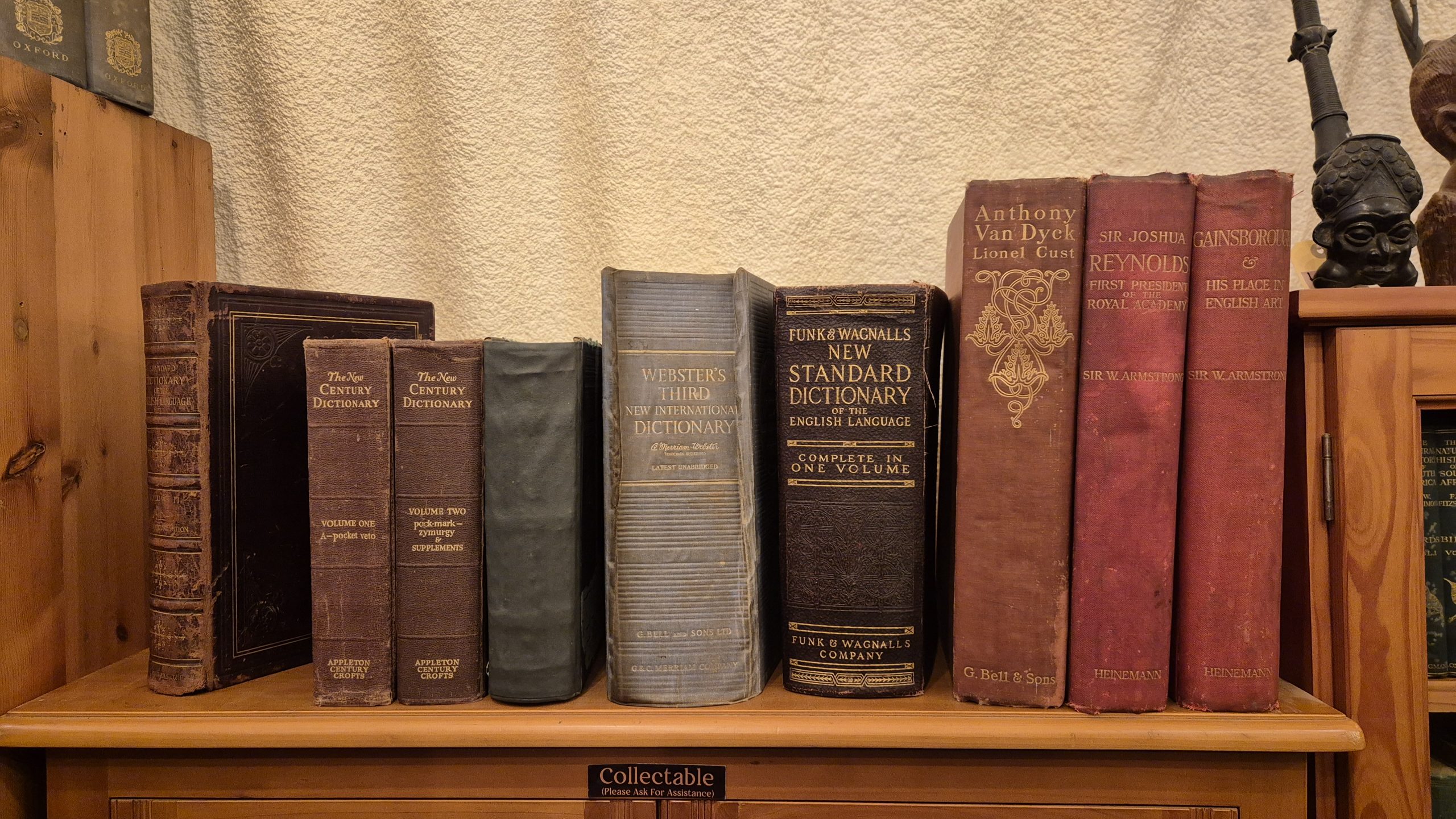 Old books stored upright on a shelf, kept cool and dry