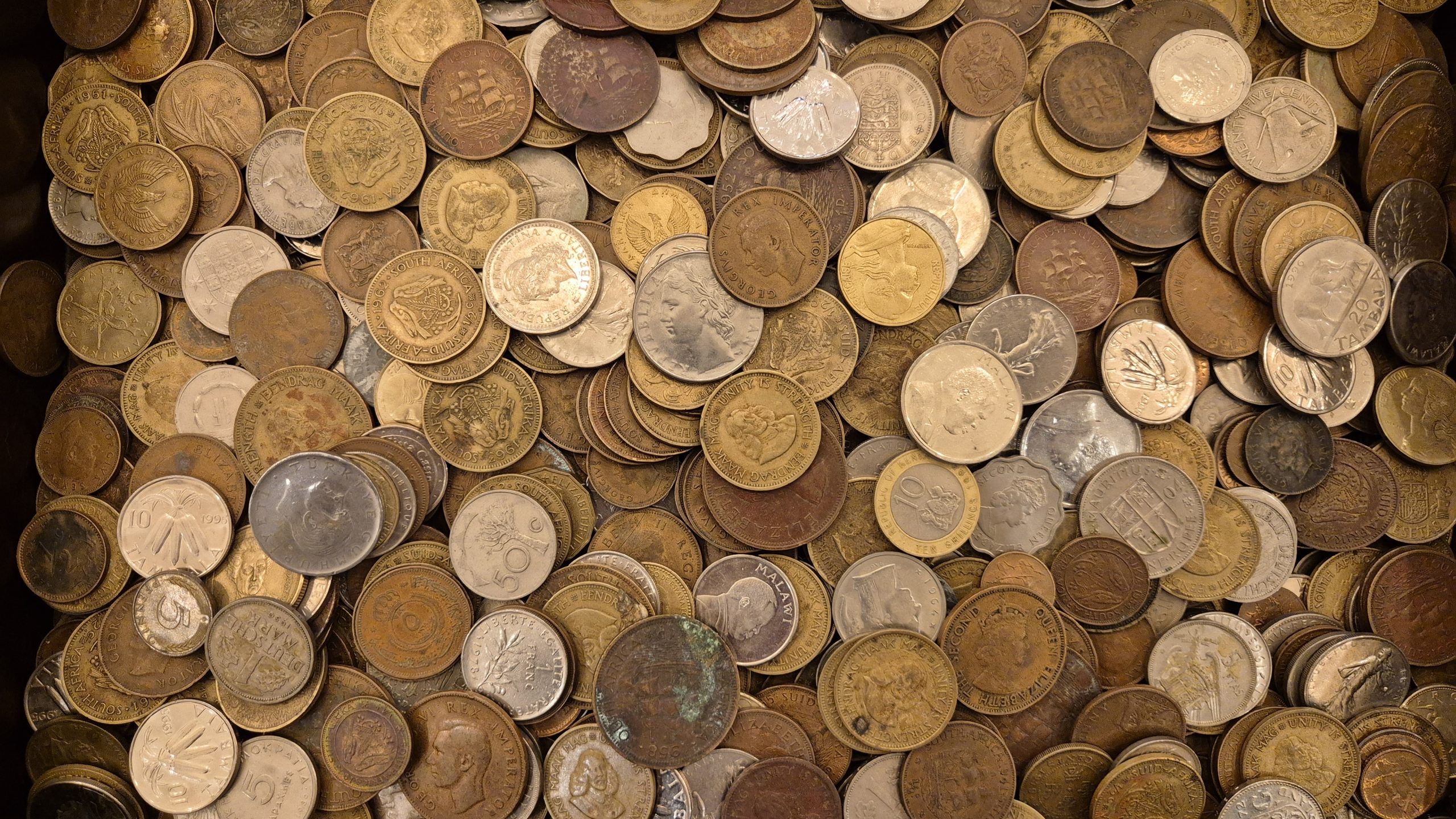 A selection of old South African coins laid out to check their collectable value